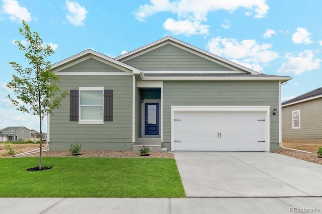 ranch-style house with a front yard, concrete driveway, and an attached garage