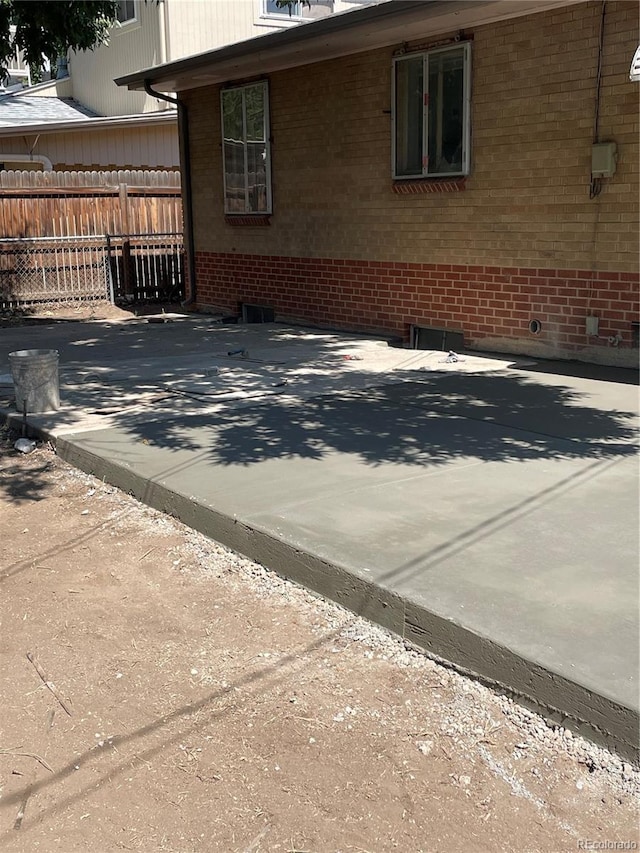 view of patio featuring fence