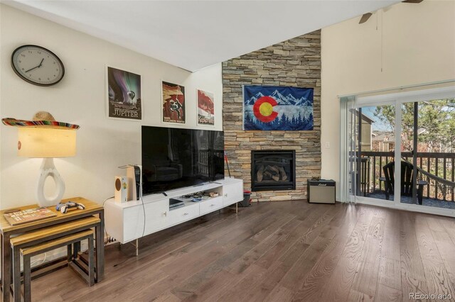 living area with lofted ceiling, wood finished floors, and a fireplace