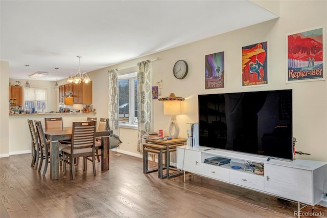 dining room with wood finished floors, baseboards, and a chandelier