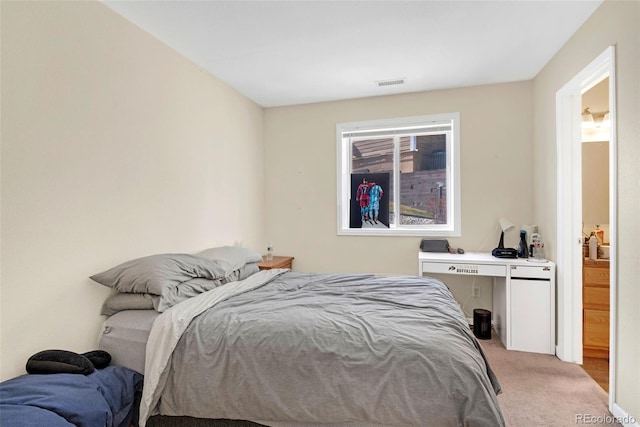 bedroom with visible vents and light colored carpet