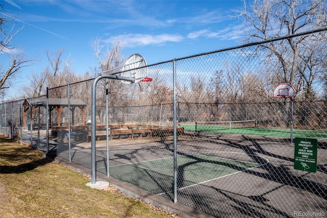 view of basketball court with community basketball court and fence