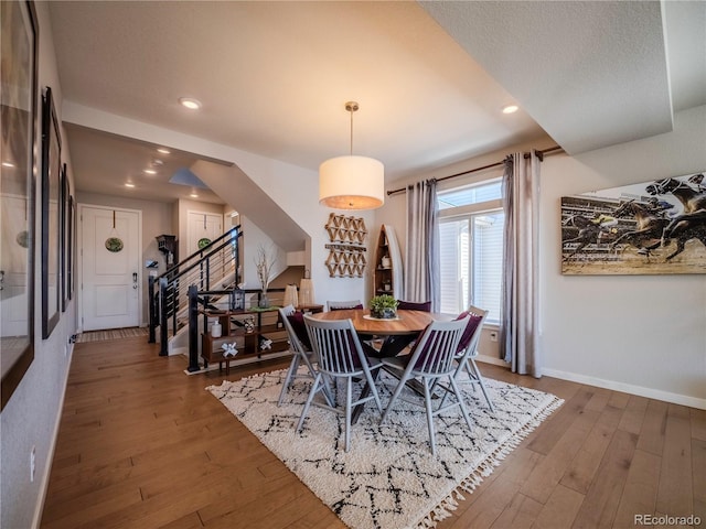 dining space with recessed lighting, stairway, a textured ceiling, wood finished floors, and baseboards