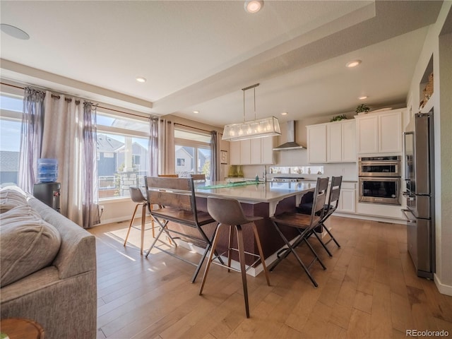 dining area with recessed lighting, baseboards, and light wood finished floors