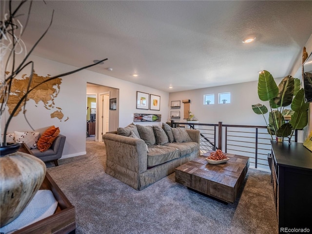 living area featuring a textured ceiling and dark colored carpet