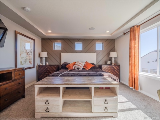 carpeted bedroom featuring multiple windows, wood walls, and baseboards