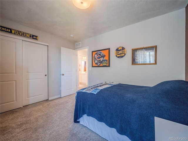 bedroom with carpet floors, visible vents, and a closet