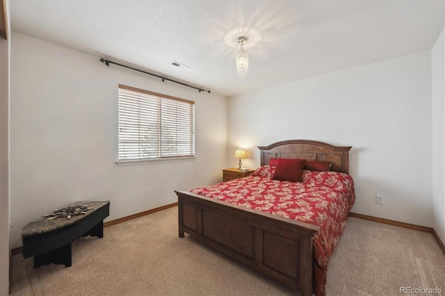 bedroom with light carpet, baseboards, and visible vents