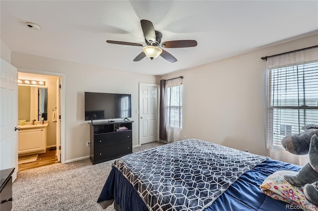 bedroom with ceiling fan, carpet, and ensuite bathroom