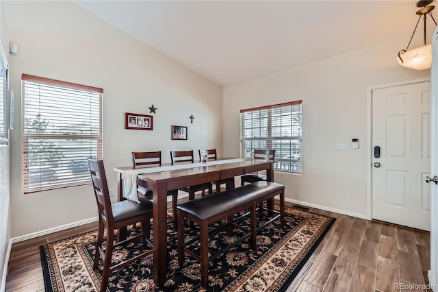 dining area with hardwood / wood-style flooring and lofted ceiling