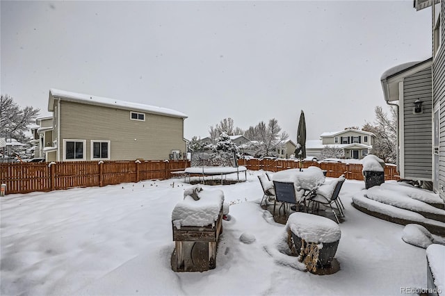 snowy yard with a trampoline