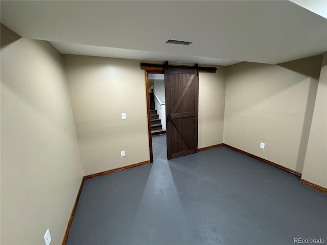 1625 N Downing St, Denver, CO 80218 - unfurnished room with baseboards, a barn door, and finished concrete floors