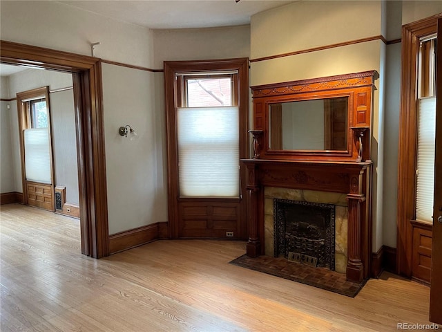 1625 N Downing St, Denver, CO 80218 - unfurnished living room featuring healthy amount of natural light, light wood-style floors, a fireplace with flush hearth, and baseboards