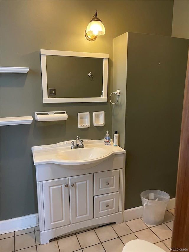 1625 N Downing St, Denver, CO 80218 - bathroom with baseboards, vanity, tile patterned flooring, and toilet