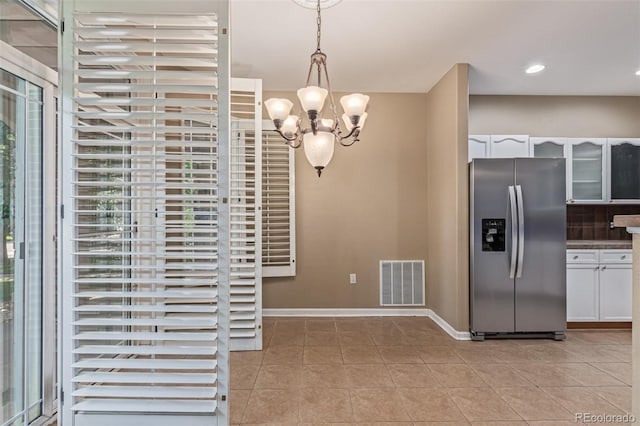 8427 S Hoyt Way Unit 107, Littleton, CO 80128 - unfurnished dining area with light tile patterned floors, a chandelier, and recessed lighting