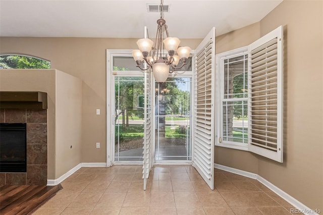 8427 S Hoyt Way Unit 107, Littleton, CO 80128 - tiled entryway with a chandelier and a tile fireplace