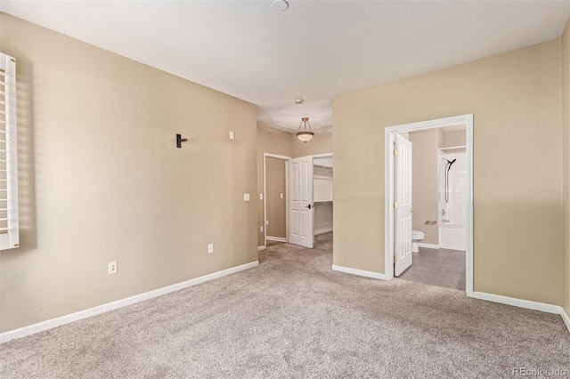 8427 S Hoyt Way Unit 107, Littleton, CO 80128 - unfurnished bedroom with carpet, a spacious closet, and ensuite bathroom