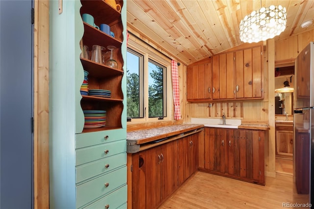 256 Fisk Fenner Rd, Allenspark, CO 80510 - kitchen featuring open shelves, brown cabinetry, light countertops, light wood finished floors, and wood ceiling