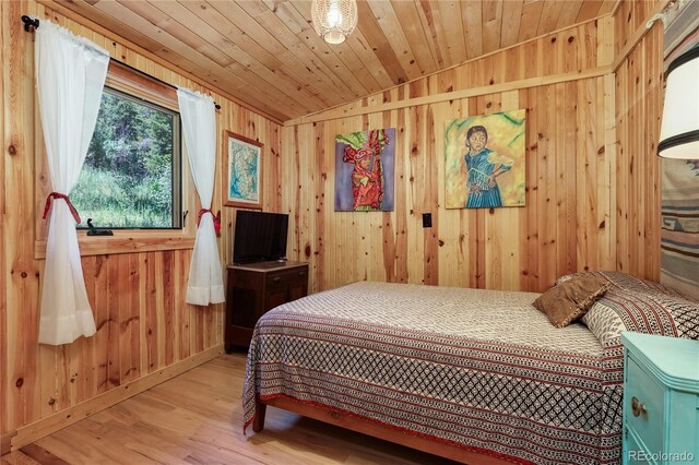 256 Fisk Fenner Rd, Allenspark, CO 80510 - bedroom featuring light wood-type flooring, wood walls, and wood ceiling