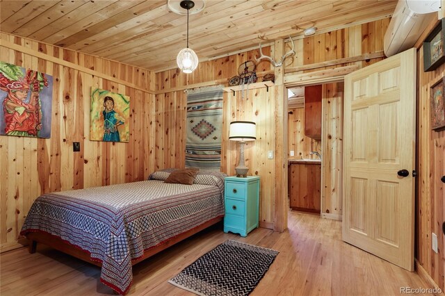 256 Fisk Fenner Rd, Allenspark, CO 80510 - bedroom with wooden walls, light wood-style flooring, and wooden ceiling