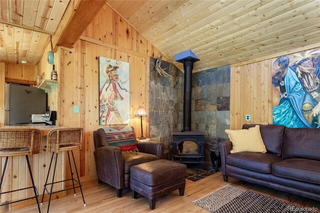 256 Fisk Fenner Rd, Allenspark, CO 80510 - living area with wood walls, a wood stove, wooden ceiling, wood finished floors, and lofted ceiling