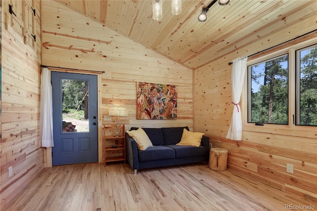 256 Fisk Fenner Rd, Allenspark, CO 80510 - sitting room with wood ceiling, wood walls, plenty of natural light, light wood-type flooring, and high vaulted ceiling