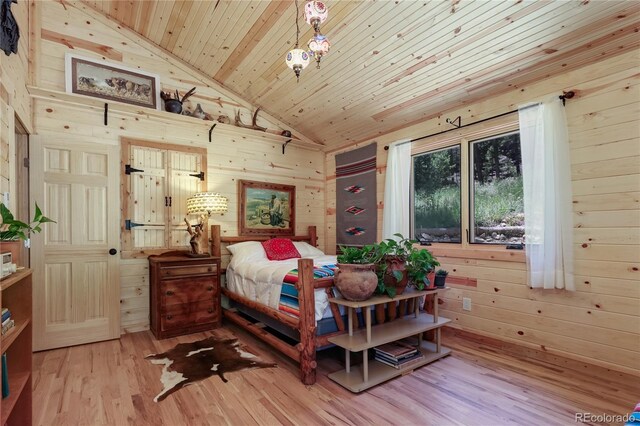 256 Fisk Fenner Rd, Allenspark, CO 80510 - bedroom featuring wooden walls, wood finished floors, wooden ceiling, and high vaulted ceiling