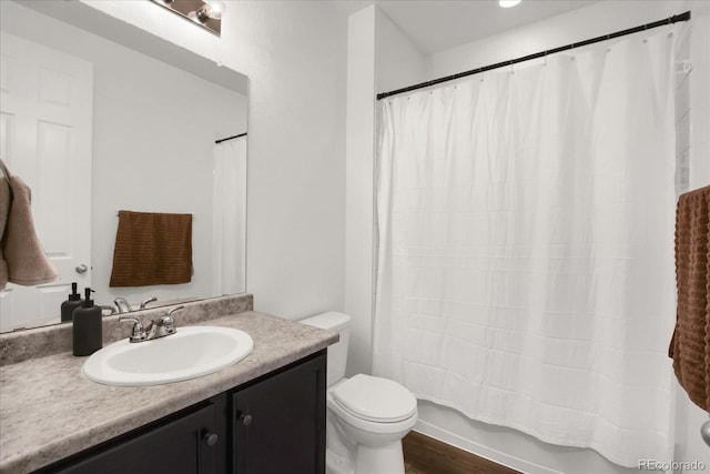 full bath featuring toilet, vanity, shower / tub combo, and wood finished floors