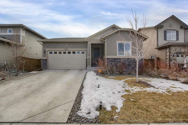 view of front of property with stone siding, concrete driveway, and an attached garage