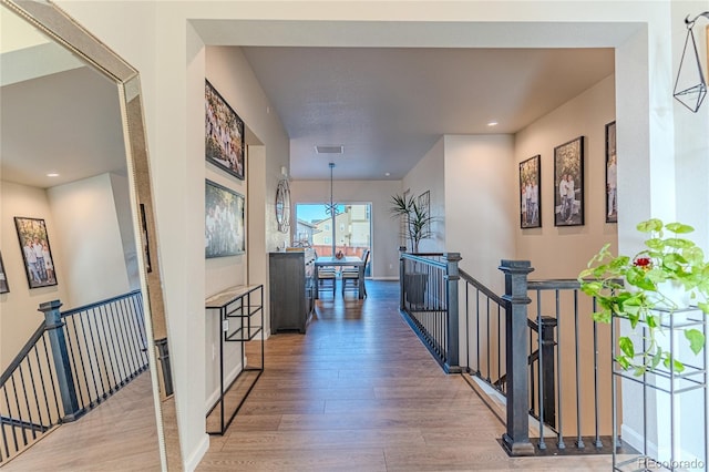 hallway with hardwood / wood-style flooring