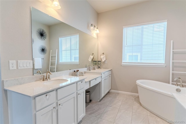 bathroom featuring a bath, vanity, and tile patterned floors