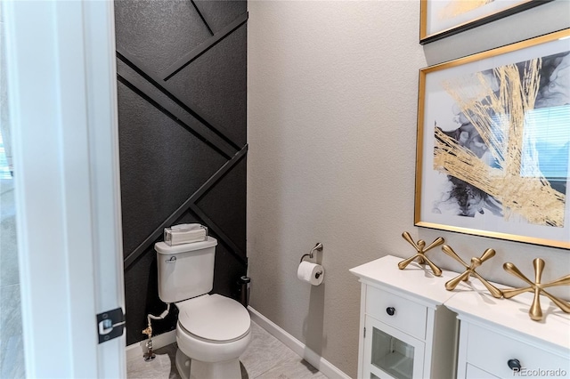 bathroom with tile patterned flooring and toilet