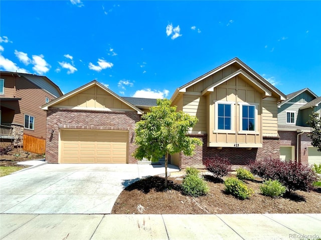 425 W 128th Dr, Westminster, CO 80234 - view of front of home with board and batten siding, an attached garage, brick siding, and concrete driveway