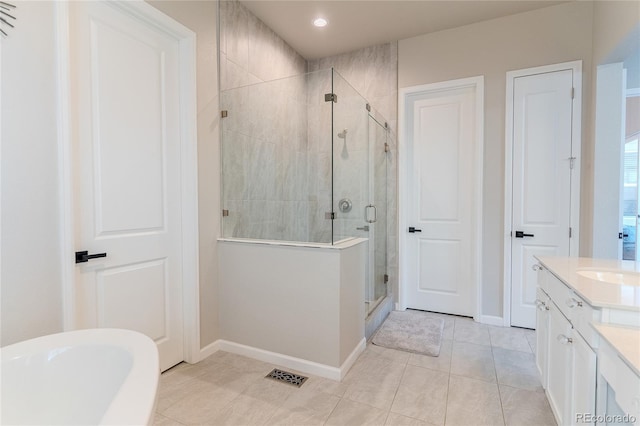 425 W 128th Dr, Westminster, CO 80234 - bathroom with a stall shower, baseboards, vanity, tile patterned floors, and a soaking tub