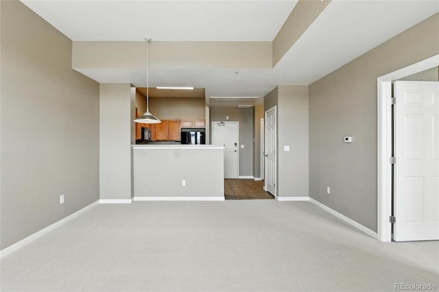 7931 W 55th Ave Unit 105, Arvada, CO 80002 - unfurnished living room featuring dark colored carpet and baseboards