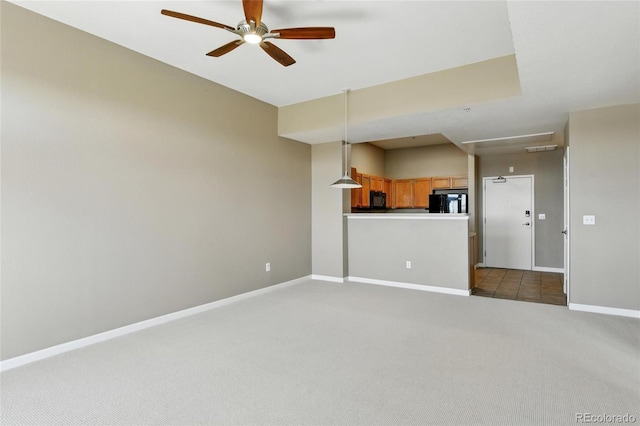 7931 W 55th Ave Unit 105, Arvada, CO 80002 - unfurnished living room featuring dark carpet and a ceiling fan