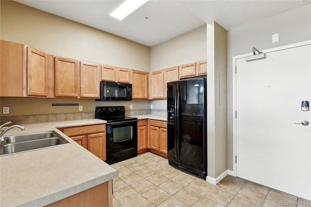 7931 W 55th Ave Unit 105, Arvada, CO 80002 - kitchen with black appliances, light tile patterned flooring, light brown cabinets, and light countertops