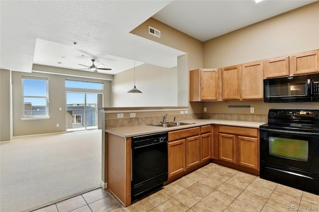 7931 W 55th Ave Unit 105, Arvada, CO 80002 - kitchen featuring black appliances, ceiling fan, open floor plan, light countertops, and light tile patterned floors