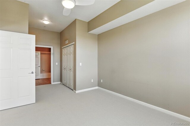 7931 W 55th Ave Unit 105, Arvada, CO 80002 - unfurnished bedroom featuring light carpet, a closet, and ceiling fan