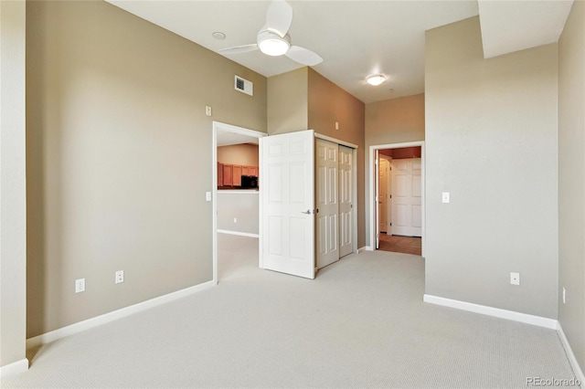 7931 W 55th Ave Unit 105, Arvada, CO 80002 - unfurnished bedroom featuring carpet, a closet, and ceiling fan