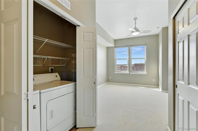 7931 W 55th Ave Unit 105, Arvada, CO 80002 - washroom featuring a ceiling fan, light colored carpet, and washer and clothes dryer