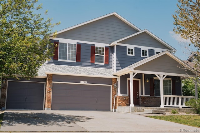 view of front of house with a porch, brick siding, an attached garage, and concrete driveway