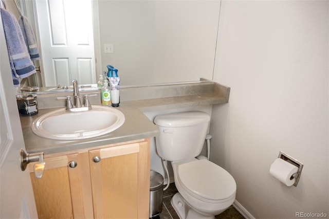 bathroom featuring toilet and vanity