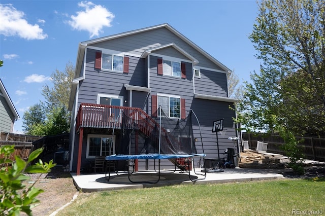 rear view of house featuring a patio area, a fenced backyard, and a deck