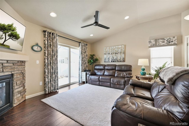 living room featuring a fireplace, dark wood-type flooring, ceiling fan, and lofted ceiling