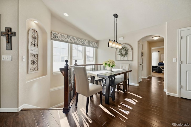 dining space with lofted ceiling and dark hardwood / wood-style floors