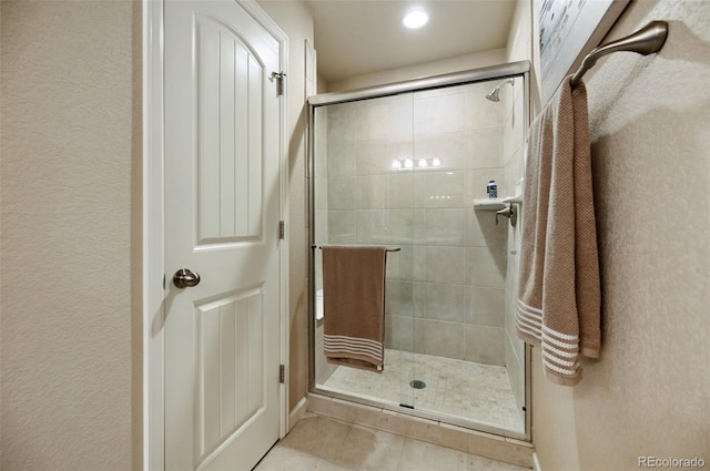 bathroom with tile patterned flooring and walk in shower