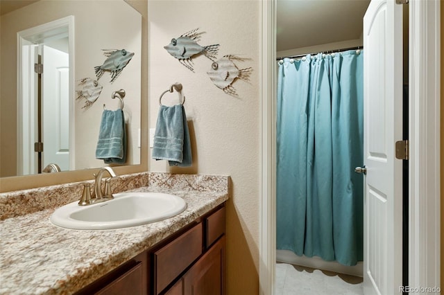 bathroom featuring curtained shower and vanity