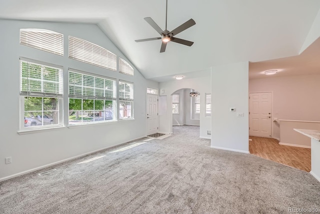 unfurnished living room featuring high vaulted ceiling, ceiling fan, and light wood-type flooring