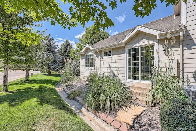 view of property exterior featuring a lawn